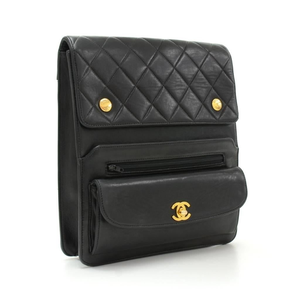 Chanel shoulder bag in black quilted leather. It has 3 pockets on front and 2 pockets on back. Main access is secured with flap and 2 stud closure. Inside has Chanel red leather with 2 pockets: 1 with zipper and 1 open. Comfortably carried on
