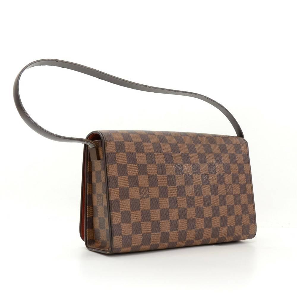Louis Vuitton Tribeca Long bag in Damier Ebene canvas. It is beautiful design with long flap leather strap. Flap top is secured with magnetic closure. Inside is red lining with 1 open and 1 zip pocket. 

Made in: France
Serial Number: TH1001
Size: