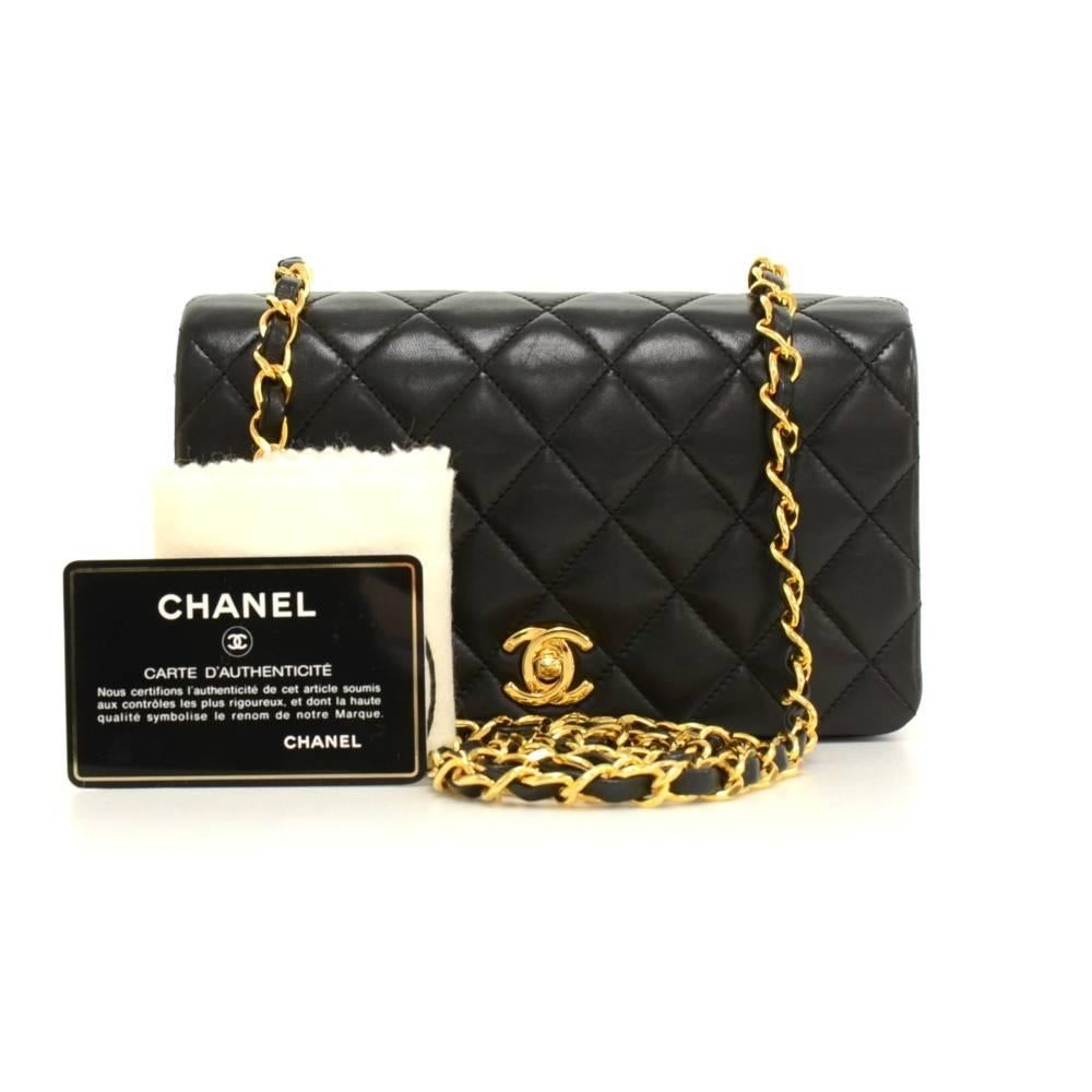 Chanel quilted mini shoulder bag in black quilted leather. It has a flap top with CC twist lock on the front. Inside has Chanel red leather lining and 1 open pocket split into 3 compartments. Comfortably carried on shoulder or across body. Very