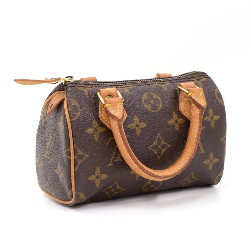 Louis Vuitton handbag Mini Speedy Sac HL, one of the most popular line in LV monogram canvas. Brass zipper securing access. Inside is brown lining. Very cute item to have. 

Made in: France
Serial Number: T H 1 9 2 5
Size: 5.9 x 3.9 x 2.8 inches or