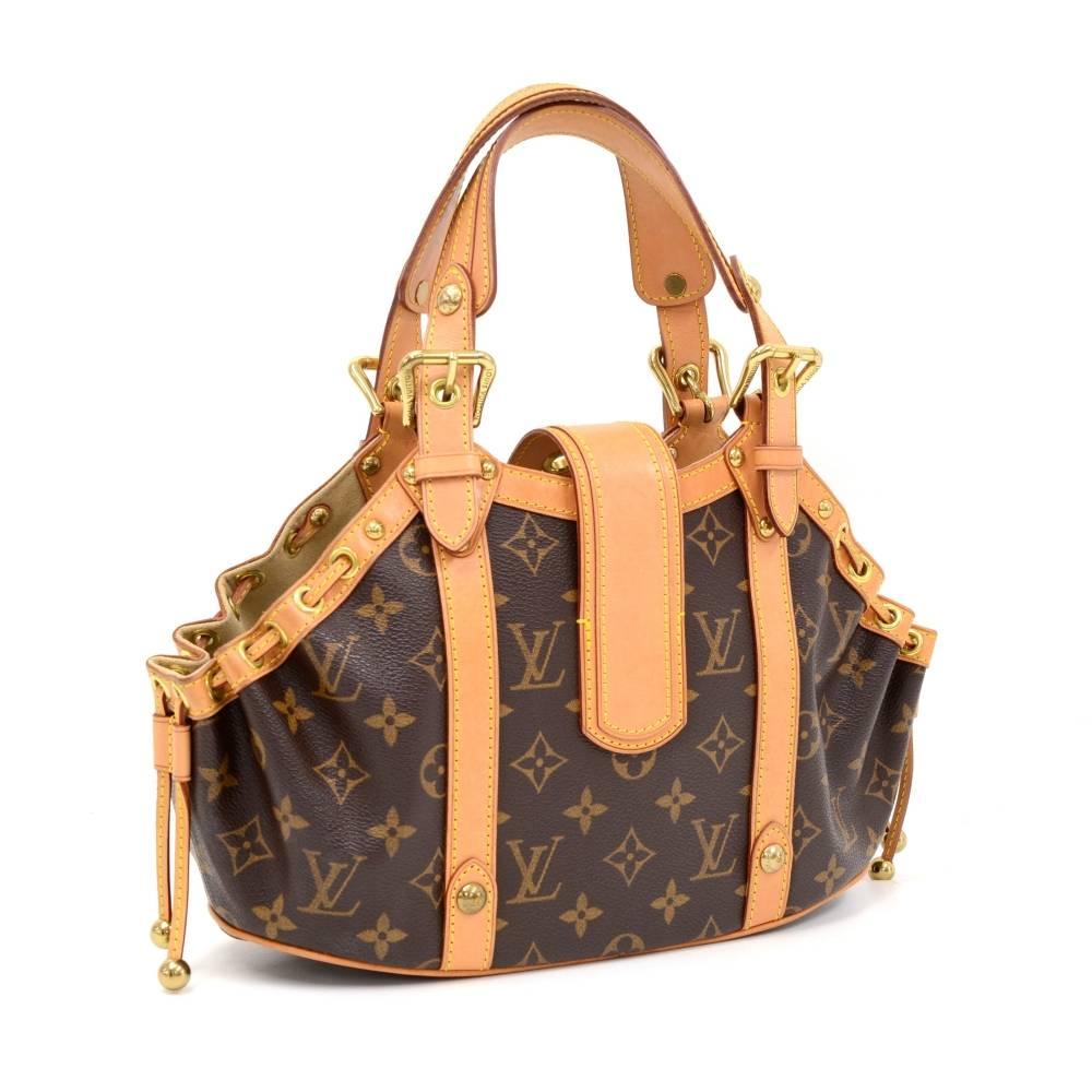 Louis Vuitton Theda PM bag monogram canvas. Top is secured with leather belt and buckle closure. Inside has beige leather lining with 1 open pocket.

Made in: France
Serial Number: F L 0 0 6 4
Size: 10.2 x 5.9 x 3 inches or 26 x 15 x 7.5 cm
Color:
