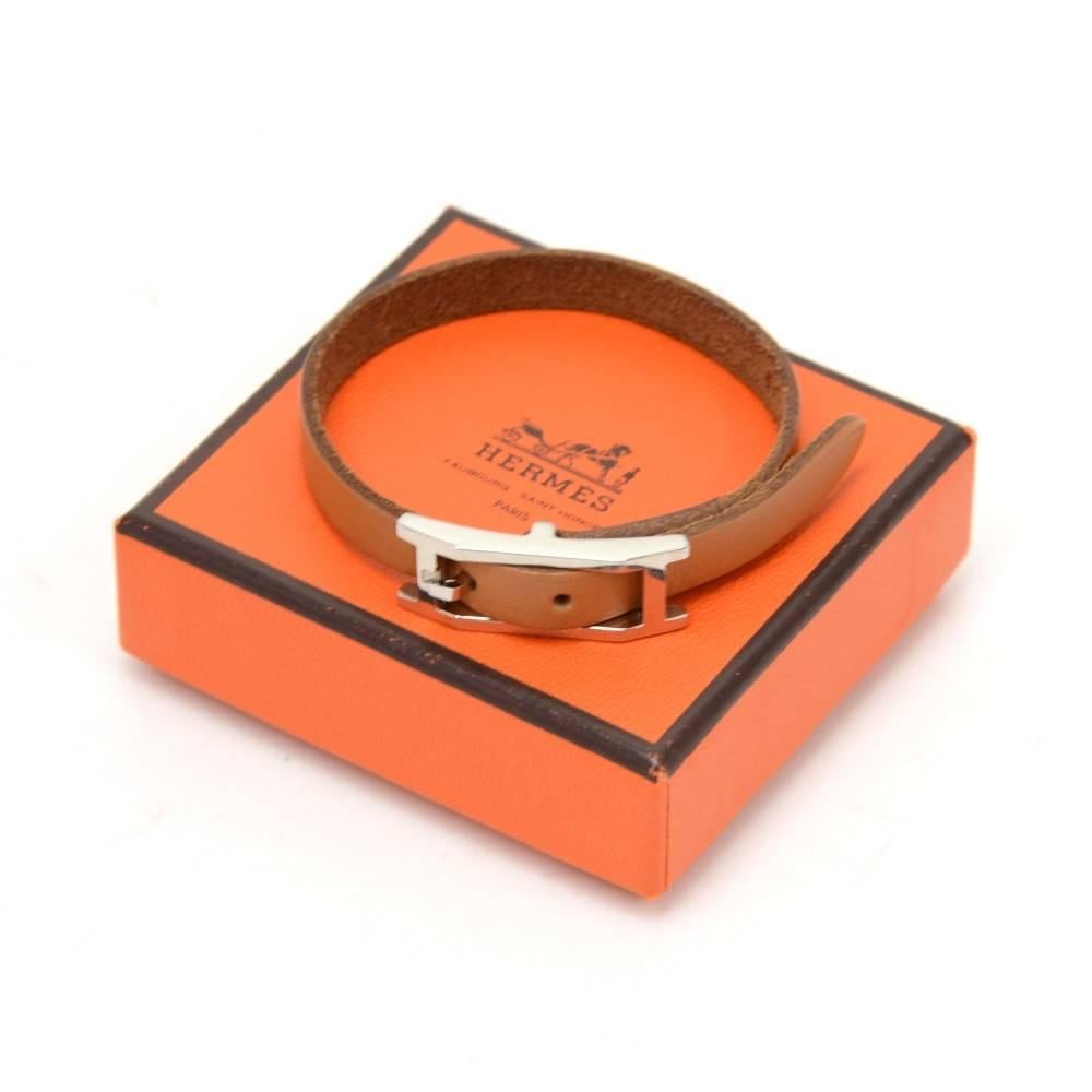 This is Hermes Api III brown leather bracelet with silver tone. Hermes Paris is engraved on it. It looks very stylish and would make a great statement.Size: Adjustable between 6.7 - 7.5 inches or 17 - 19 cm.

Made in: France
Serial Number: G 2003