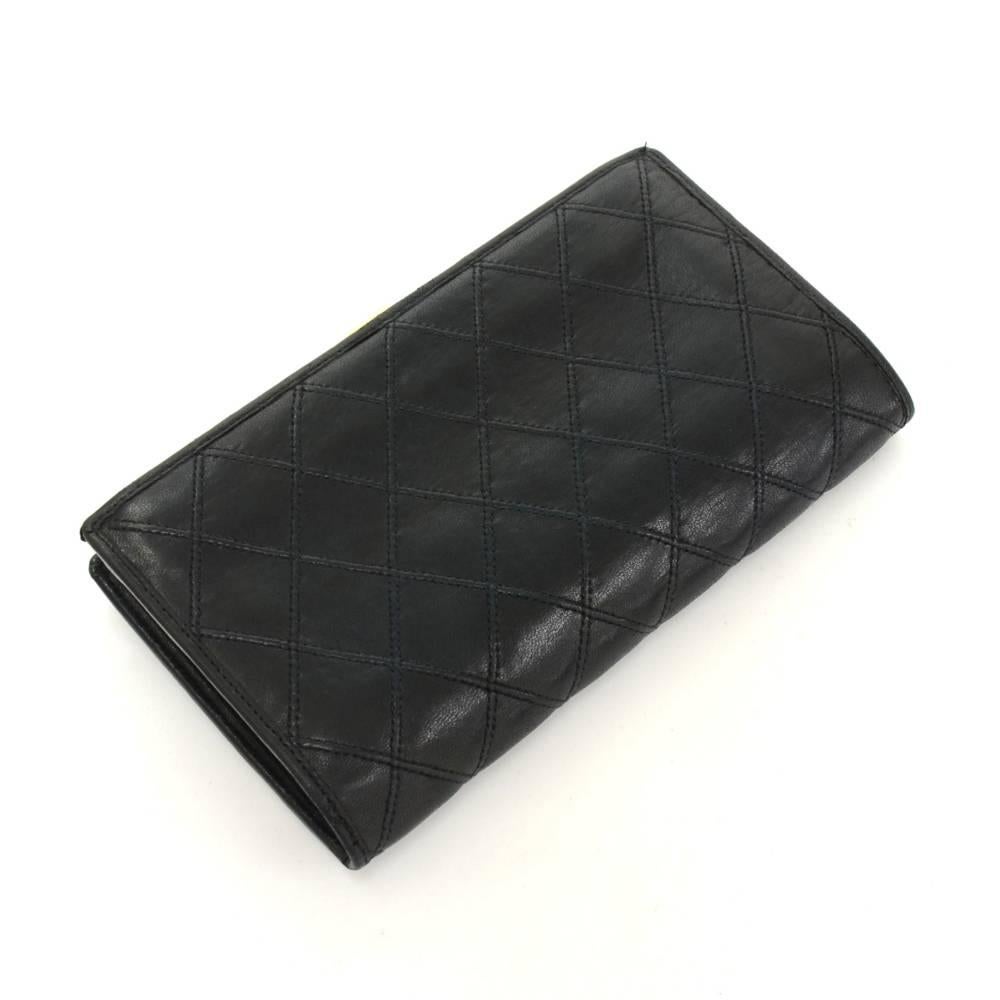Chanel black quilted leather wallet. It is secured with stud. Inside has 1 coin compartment with lock, 1 note compartment, 2 open pockets and 6 card slots. Very cute and make great companion where you go!

Made in: France
Size: 3.9 x 6.7 x 0.4