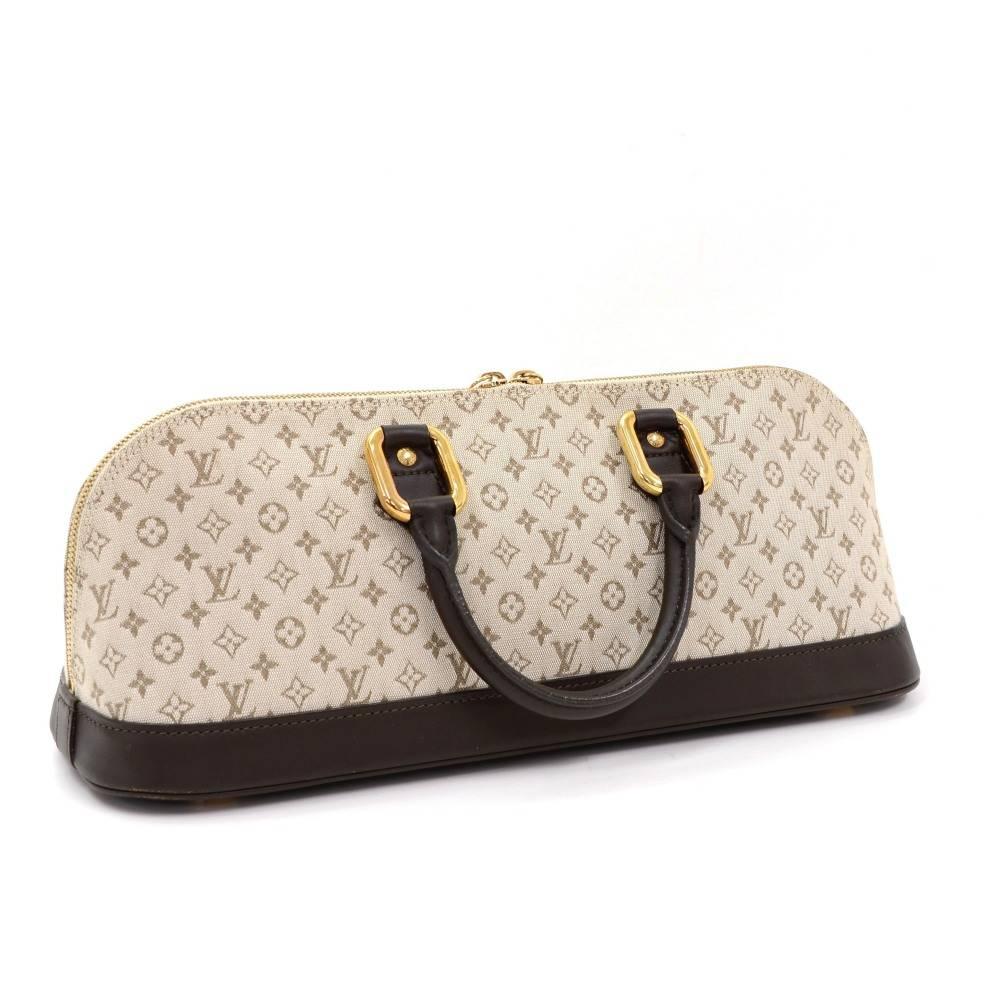 Louis Vuitton Alma long in mini monogram. It is secured with double brass zipper. Inside has fabric lining with 1 zipper pocket. Carried in hand.

Made in: France
Serial Number: MI 1 0 1 1
Size: 15 x 5.9 x 5.1 inches or 38 x 15 x 13 cm
Color: