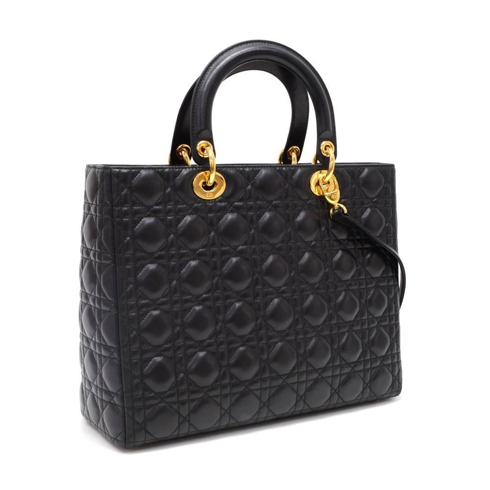 Christian Dior Lady Dior hand bag in black quilted cannage leather. Main access is secured with zipper. Inside has 1 zipper pocket and fabric lining. Comfortably carried in hand or on shoulder with additional strap.

Made in: Italy
Serial Number: MA