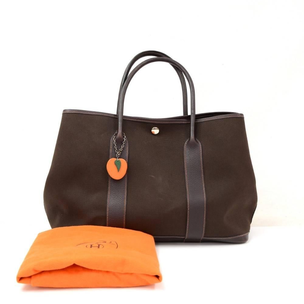 Hermes canvas and leather Garden Party PM Bag. Famous bag secured with silver tone stud in the middle and there are stud on each side as well. Hand held with great capacity simply stunning. Inside as well as on the studs is engraved HERMES PARIS. It