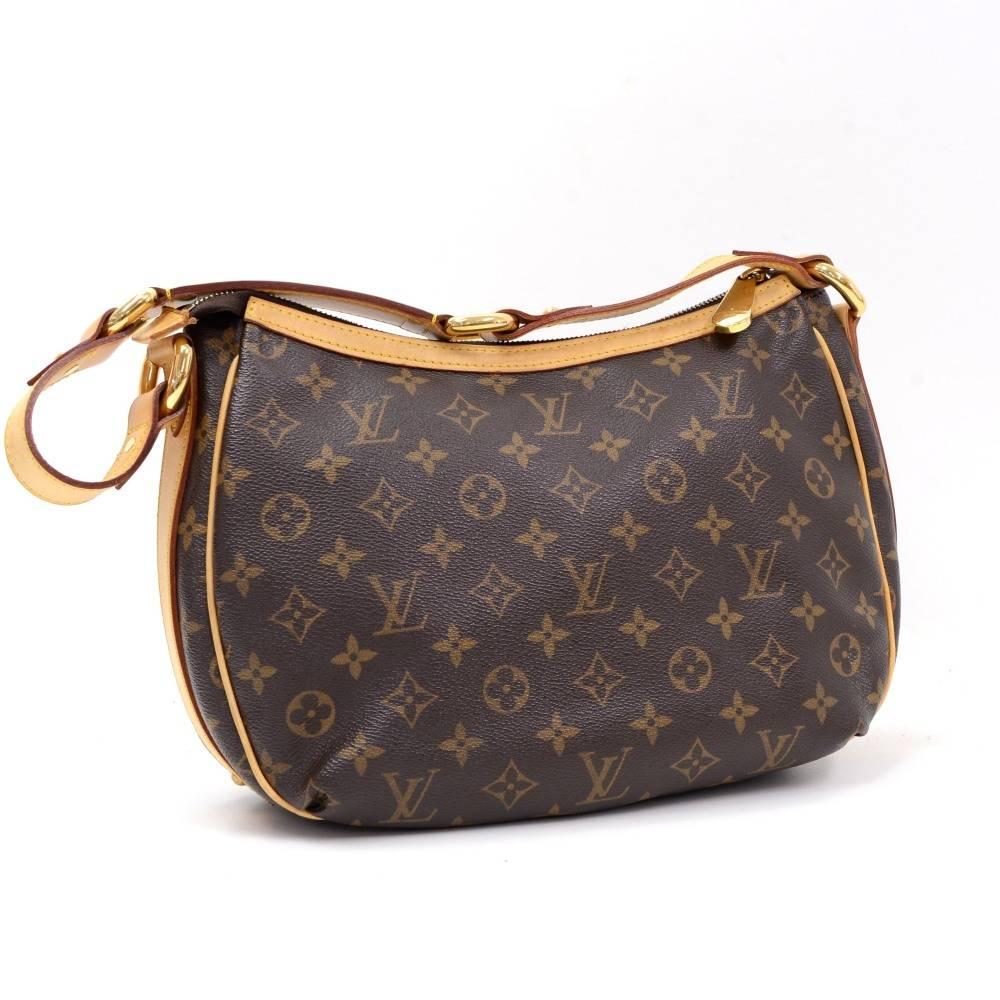 Louis Vuitton Tikal GM hand bag in monogram canvas. It has zipper closure on top with 1 pocket with flap and twist closure. Inside is in brown alkantra lining and has 1 open pocket and 1 for mobile or glass. Leather strap could be worn in hand.