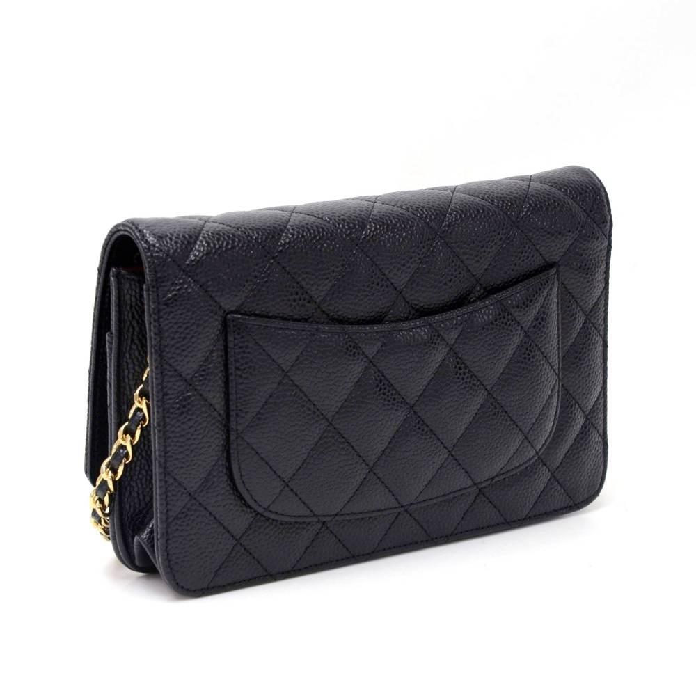 Chanel black quilted caviar leather wallet on chain. It has flap top with a secure stud and 1 open pocket on the back. Inside has 1 compartment for coin with zipper closure, 1 note compartment, 2 open pockets and 6 card holders. It has long chain