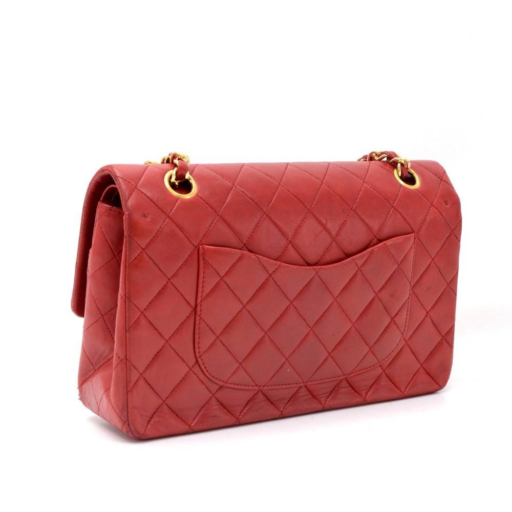 Chanel red quilted leather bag with double flap. It has CC twist lock on the front flap. Second flap has stud closure. Underneath it, there is one slip in pocket and inside lining is in famous Chanel red leather. One interior open pocket is split