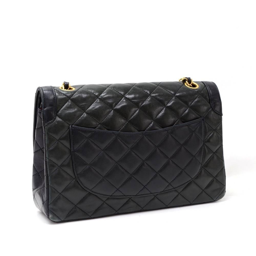 Chanel black quilted leather bag with double flap. It has CC twist lock in silver x gold tone on the front flap. Second flap has stud closure. Underneath it, there is one slip in pocket and inside lining is in famous Chanel red leather. One interior
