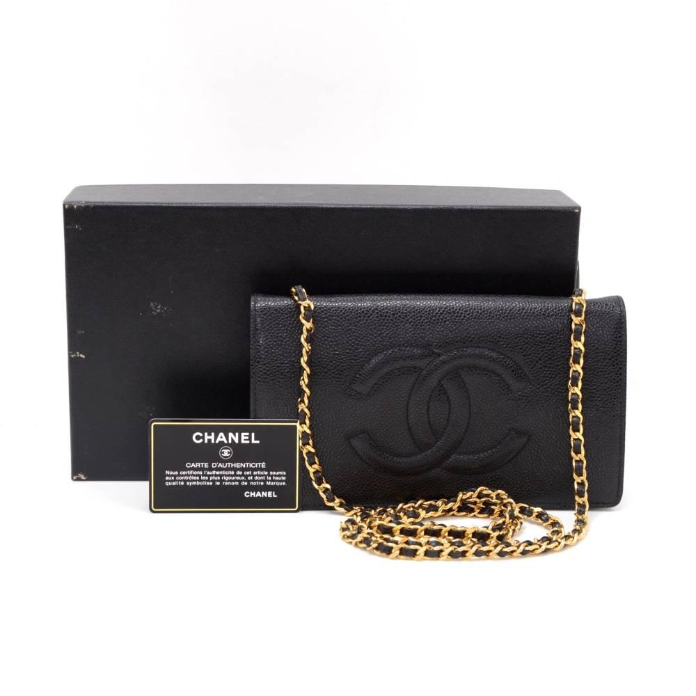 Chanel black caviar leather wallet on chain. It has flap top with a secure stud and 1 zipper pocket on the back. Inside has 1 compartment for coin with flap and stud closure, 1 zipper pocket, 3 note compartments, and 4 card holders. It has long