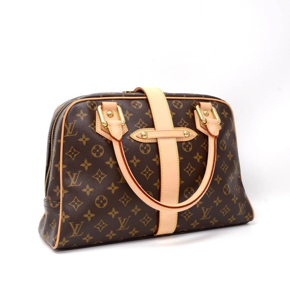 Louis Vuitton Manhattan GM in monogram canvas. Zipper closure is secured with a leather belt. On the front has 2 flap pockets with clutch closures. Inside has alkantra lining and 1 open pocket. 

Made in: France
Serial Number: F L 1 0 2 7
Size: 15 x