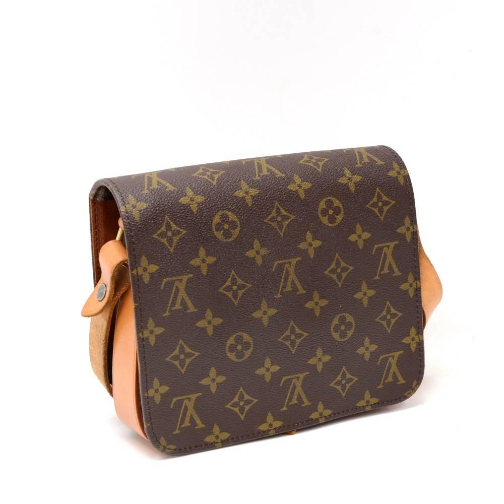 Louis Vuitton Cartouchiere MM in monogram canvas. Flap top secured with belt closure. Inside is brown washable lining. Comfortably carry on shoulder or across body with cowhide leather strap. 

Made in: France
Serial Number: 888
Size: 8.3 x 7.1 x 3