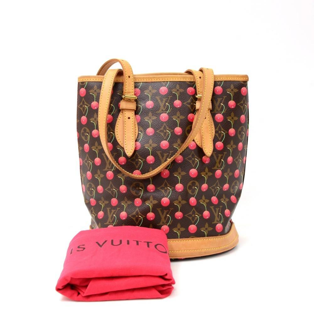 Louis Vuitton Bucket Petit in monogram cherry canvas. Supple and spacious bag carried on one shoulder or in hand. It has adjustable straps and protective brass feet. Inside are 2 pockets; one opened and one with a zipper. Limited edition from 2005.