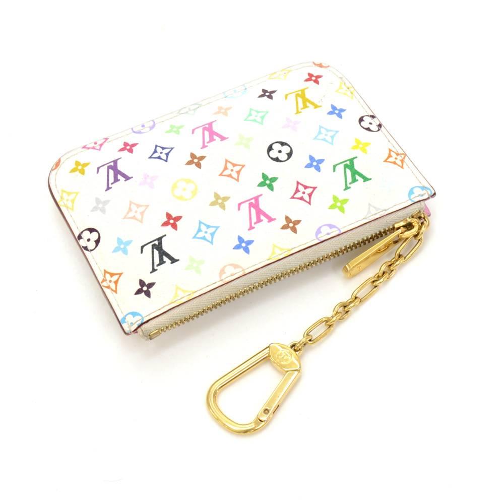 Louis Vuitton white multicolor monogram pochette key / coin case. This key case can holds coins and keys! Stunning item where you go.

Made in: France
Serial Number: S N 3 1 9 4
Size: 5.1 x 3.5 x 0 inches or 13 x 9 x 0 cm
Color: White
Dust bag:  