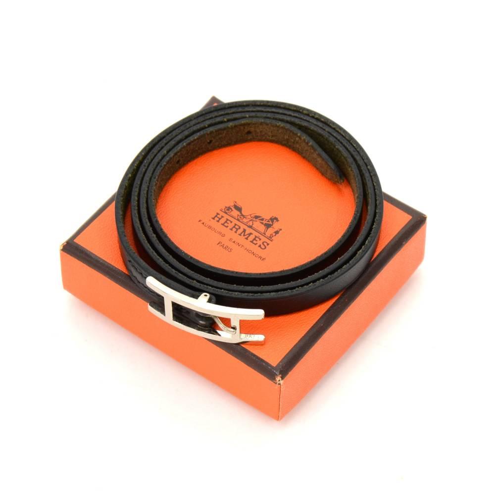 This is Hermes Api III black leather long wrap bracelet with silver tone. Hermes Paris is engraved on it. It looks very stylish and would make a great statement.Size: Adjustable between 25.6 - 26.4 inch or 65 - 67 cm.

Made in: France
Size: 26.4 x