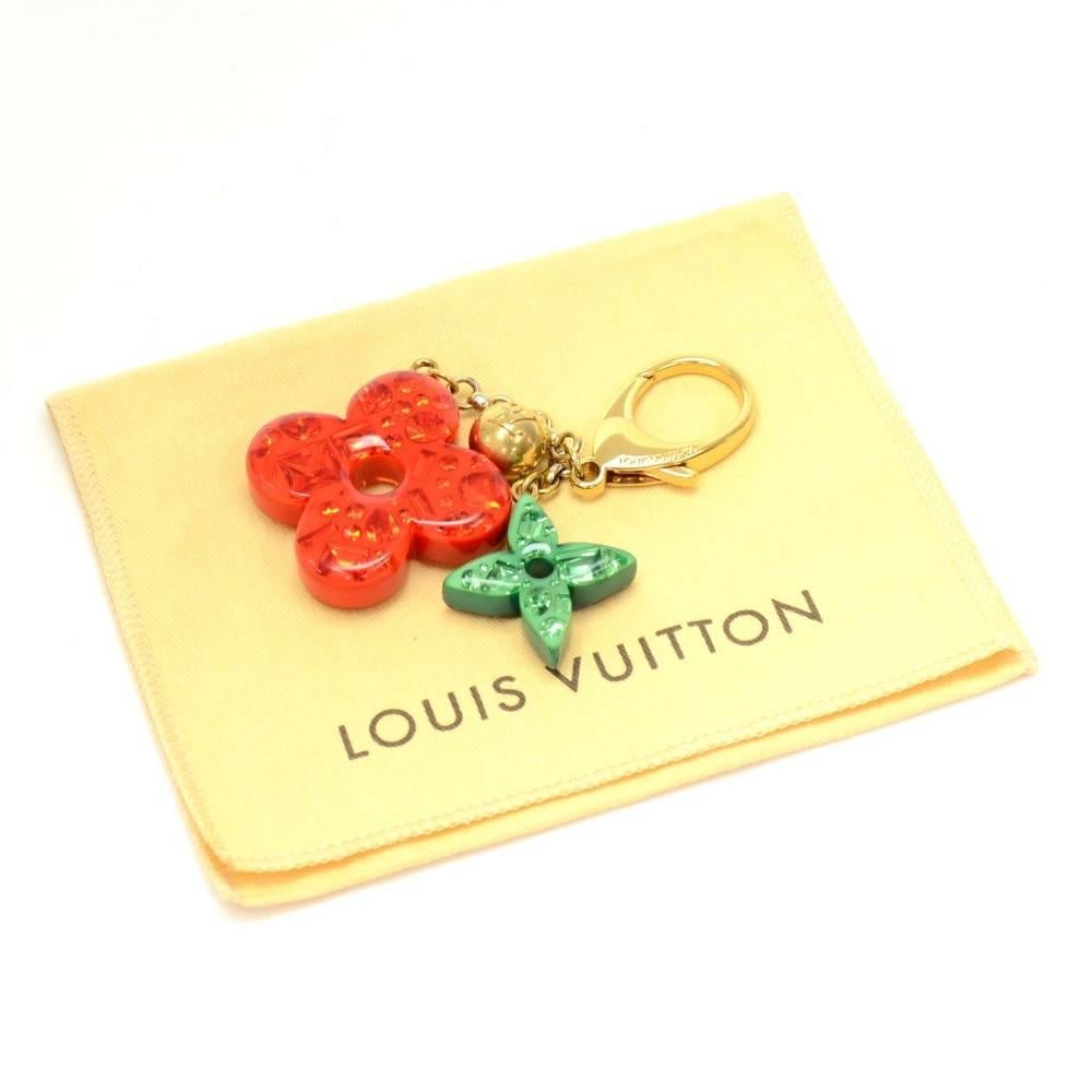 Louis Vuitton Key holder / bag charm in gold tone with reversible red/yellow and green/blue charms. Rare design would make your keys easy to find. Would as well look great hanging on your bag.

Made in: France
Size: 5.3 x 0 x 0 inches or 13.5 x 0 x