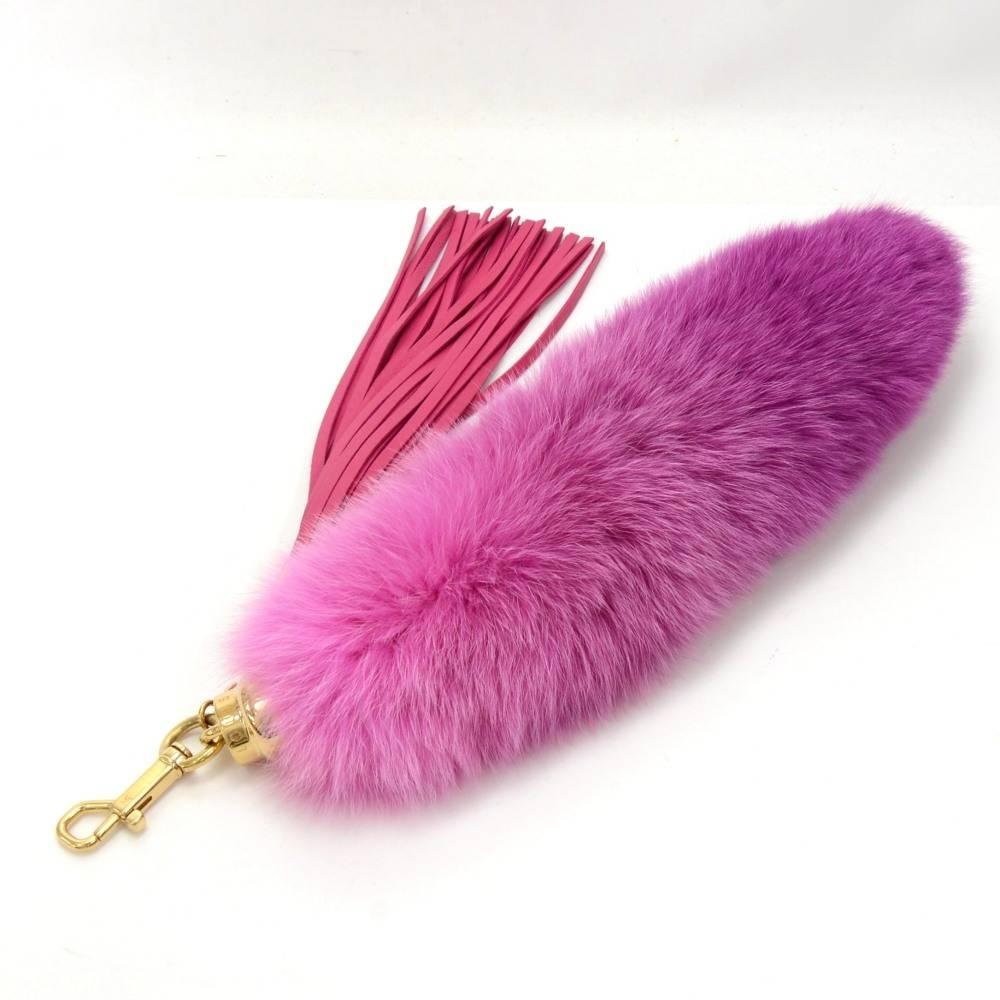 This is authentic Louis Vuitton Foxy Pompom Bag Charm in Fuchsia Pink. It comes with a pink calfskin leather fringe charm as well. Can be clasped with a brass D-ring. Would as well look great hanging on your bag.

Size: 20.5 x 5.5 x x inches or 52 x