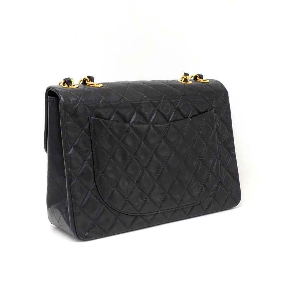 Vintage Chanel Maxi Jumbo in black quilted leather. It has flap top with famous large CC twist lock on the front. Outside on the back has 1 open side pocket. Inside has Chanel red leather lining and 2 pockets: 1 zipper and one open. Comfortably