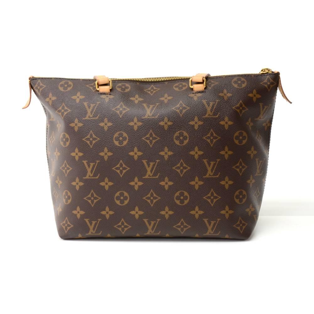 Louis Vuitton Iena MM tote bag in monogram canvas. Top has  zipper closure. Outside has one zipper pocket with leather zipper pull and a Leather flap with 