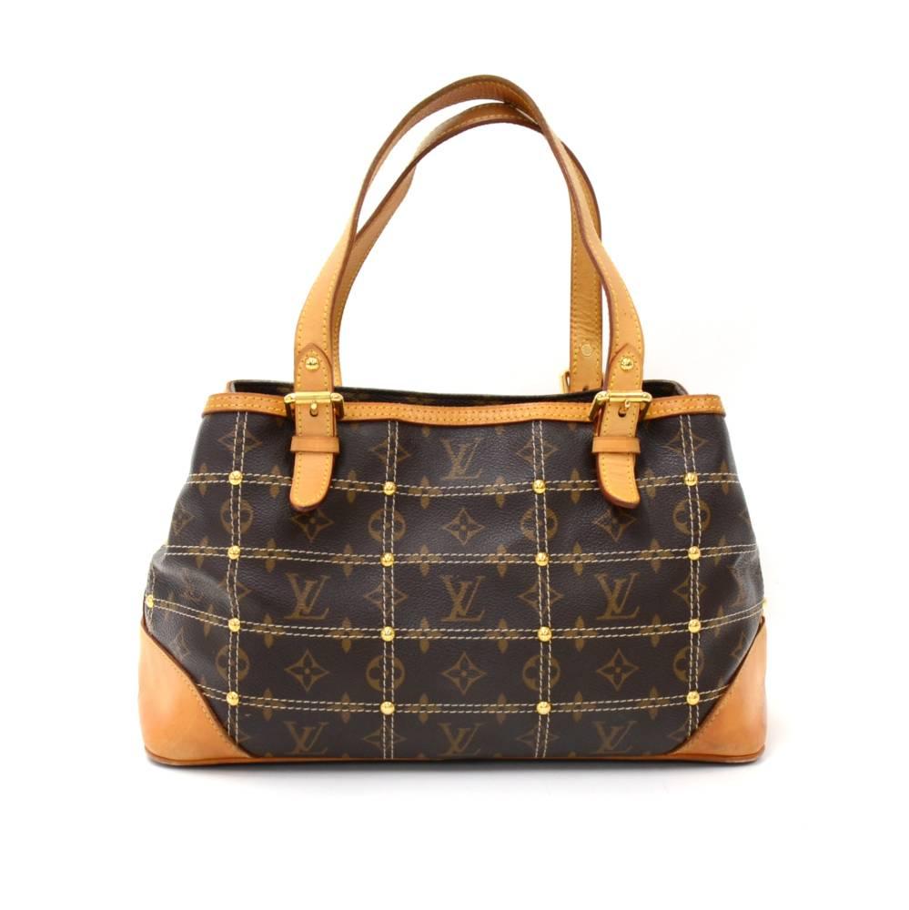 Louis Vuitton Riveting GMin monogram canvas. It is a 2007 Spring/Summer Limited edition. The bag has unique rivets (stud) details with topstitching and has a Inveteur gold tone plaque. The outside has two zipper pockets.The bag has 3 compartments: 2