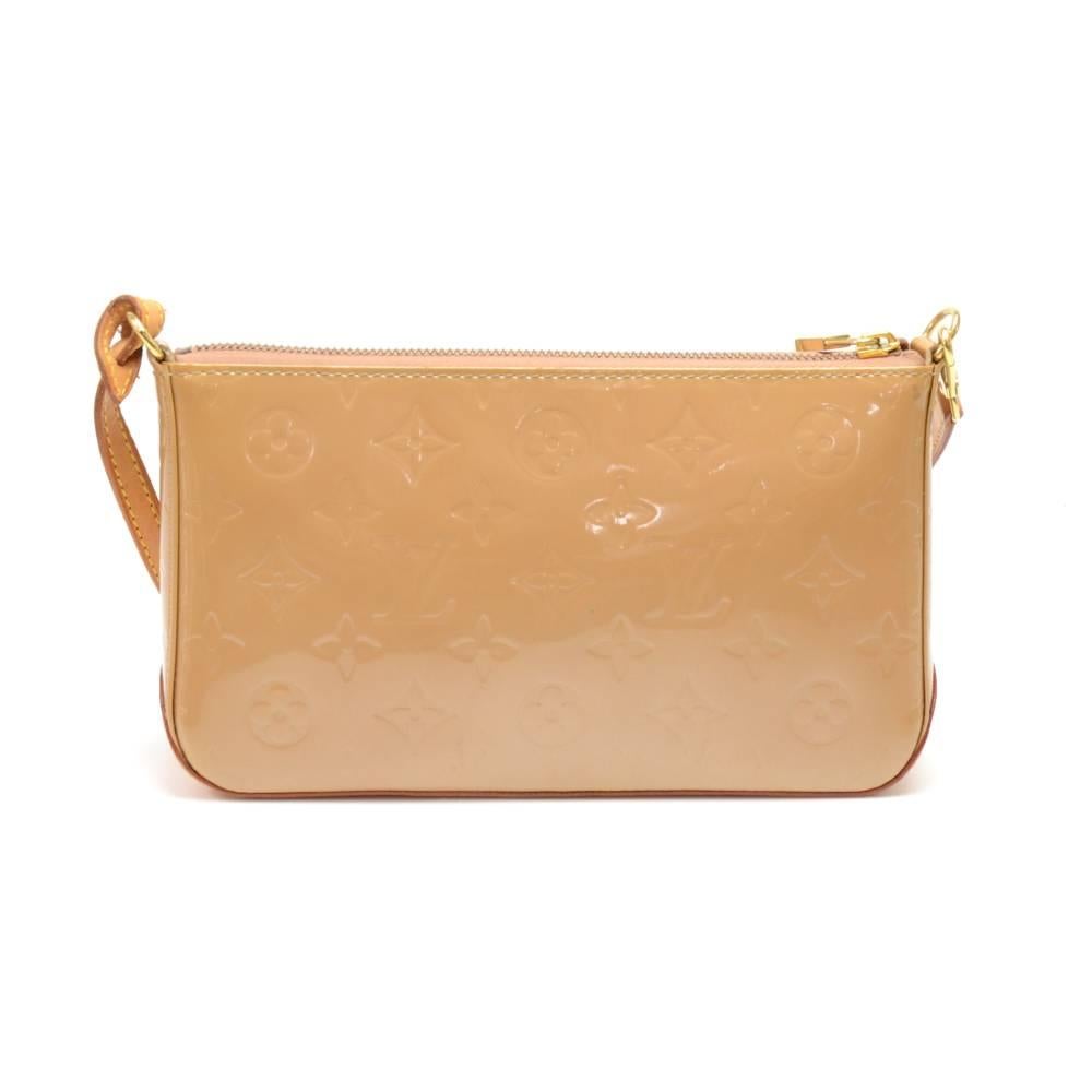 Louis Vuitton Mallory pochette in vernis monogramed leather. The outside has one slip in open pocket with a strap stud closure and zipper closure for main access. Simply carried in your hand or under shoulder. Secure gold color zipper creates easy