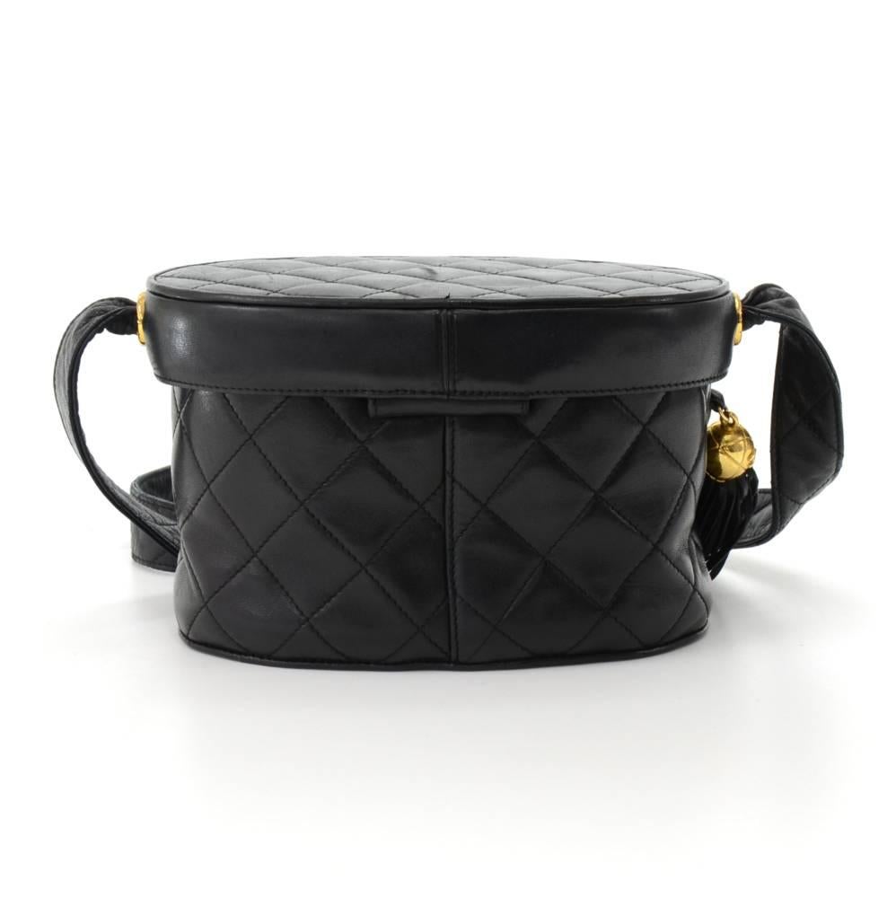 Chanel large vanity cosmetic pouch in black lambskin leather. Top is secured with a magnetic closure. Fashionable fringe attatched to the side.  Inside has black leather lining, with a handy oval mirror under flap and with 1 zipper pocket. Can be