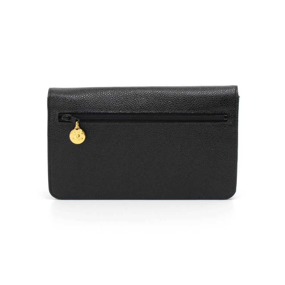 Chanel long wallet in black caviar leather. It has a flap opening with a large Chanel CC logo and closed with a push lock. Outside has one zipper pocket in back with a small round CC logo zipper charm. Inside has one zipper pocket underside of the