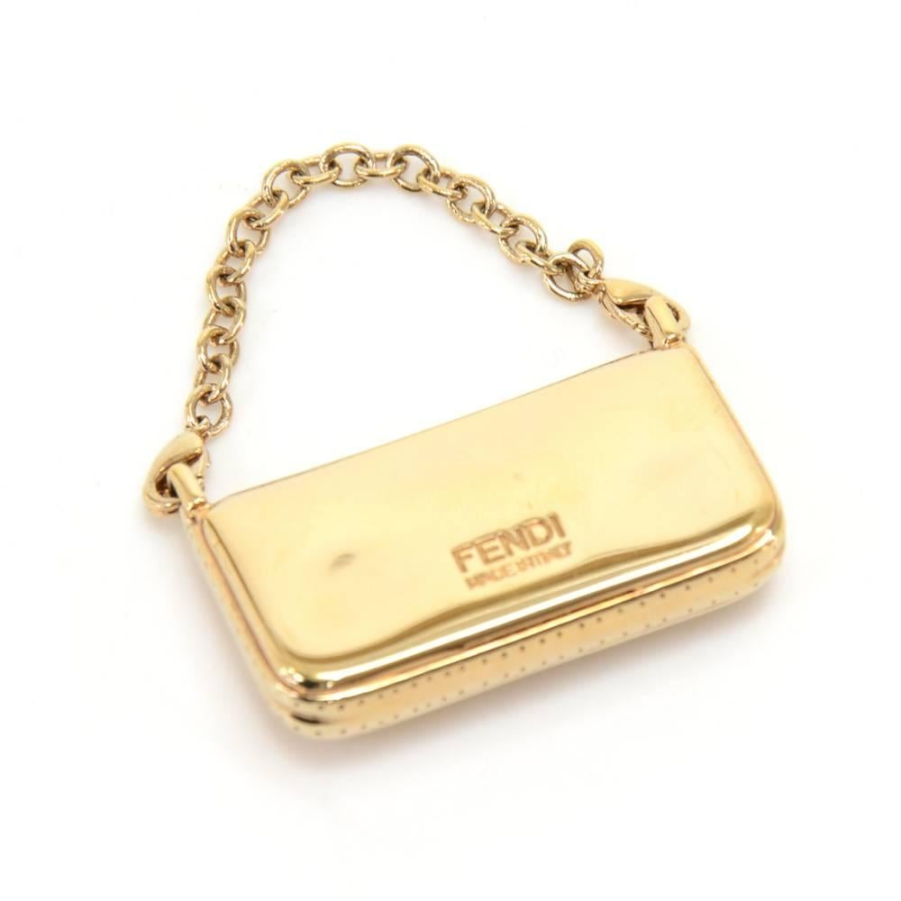 Authentic Fendi gold pendant/ charm in the shape of the classic Fendi Baguette Shoulder Bag with the FF Logo. Has a short chain with two lobster claw clasps. A great accessory for wherever you go! SKU: FA008

Made in: Italy
Size: 1.6 x 0.2 x 0.8