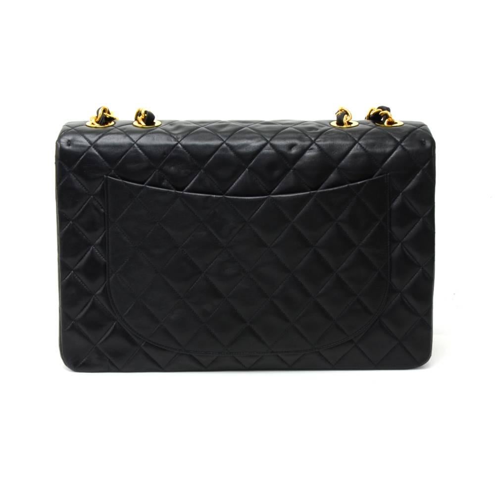  Vintage Chanel Maxi Jumbo in black quilted lambskin leather. It has flap top with famous large CC twist lock on the front. Outside on the back has 1 open side pocket. Inside has Chanel red leather lining and 2 pockets: 1 zipper and one open.