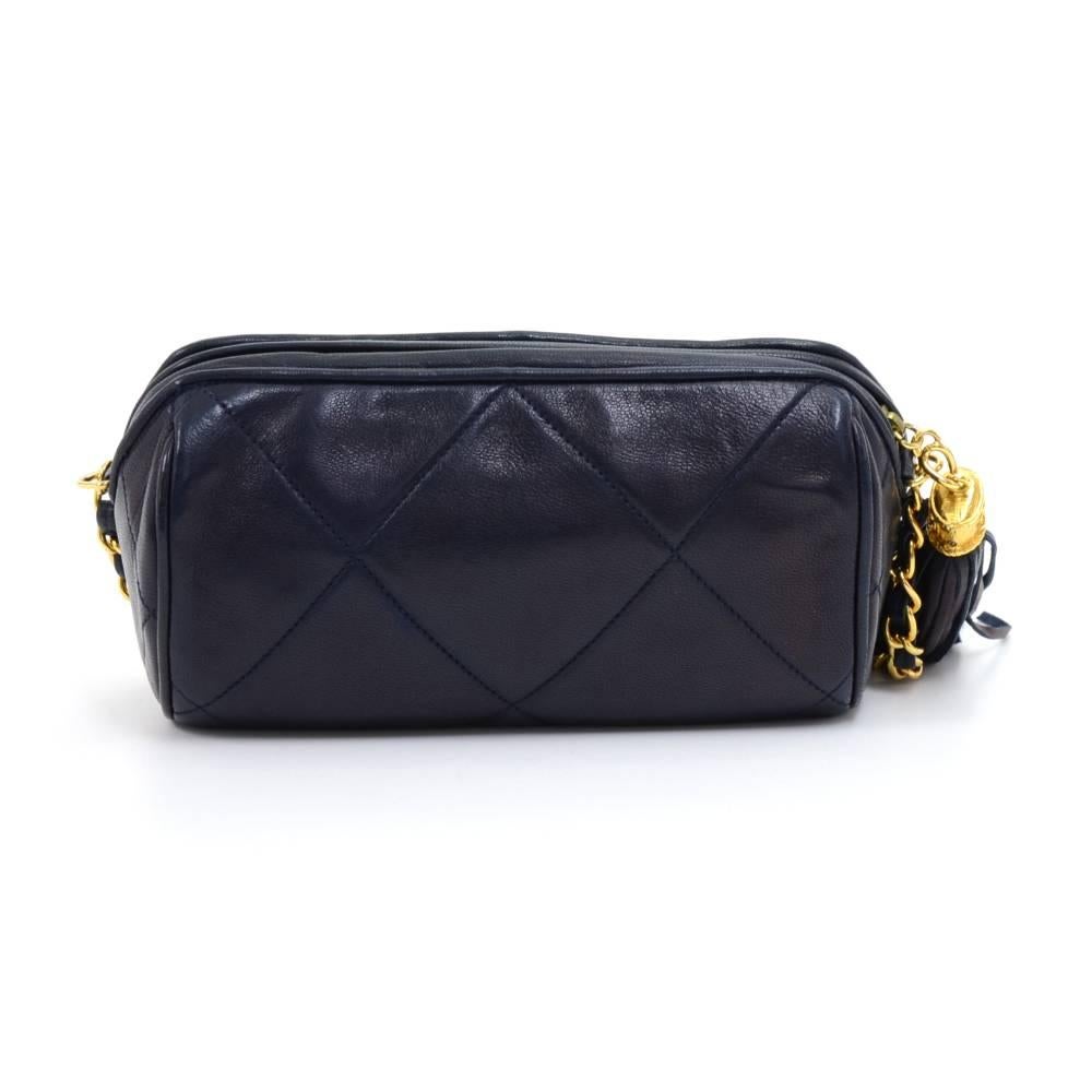 Vintage Chanel Diamond quilted barrel bag in navy lambskin leather. Outside has the CC logo stitched and debossed on the front. The main access has a zipper closure with a lovely tassel zipper pull. Inside is lined with navy leather and has one