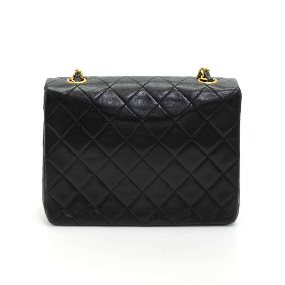 Vintage Chanel black quilted leather mini bag. It has flap and CC twist lock on the front. Inside has Chanel red leather lining and 2 pockets; 1 zipper and 1 open slit into 3 compartment. It can be carried on the shoulder or across the body with the