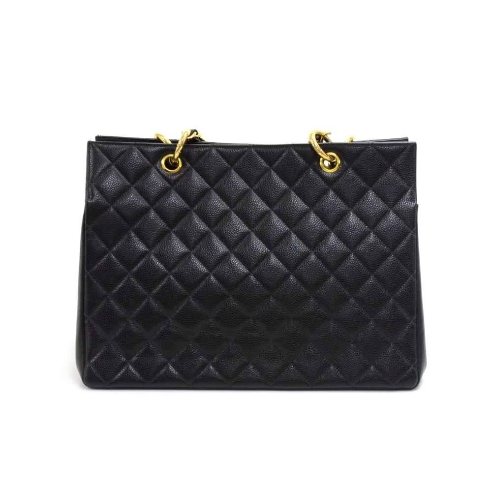 Vintage Chanel shopping tote bag in black quilted caviar leather. Outside has a large classic CC logo stitched on like the medallion style bags. It has an open access. Inside has a very spacious interior with black leather lining and one zipper and