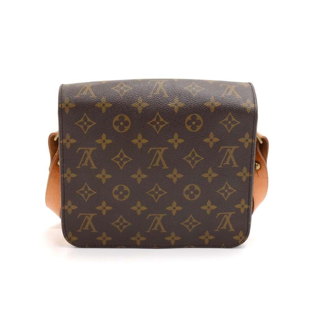Vintage Louis Vuitton Cartouchiere MM in monogram canvas. Flap top secured with belt closure. Inside is brown lining separated into two compartments. Comfortably carry on shoulder or across body with cowhide leather strap. Great for your daily or