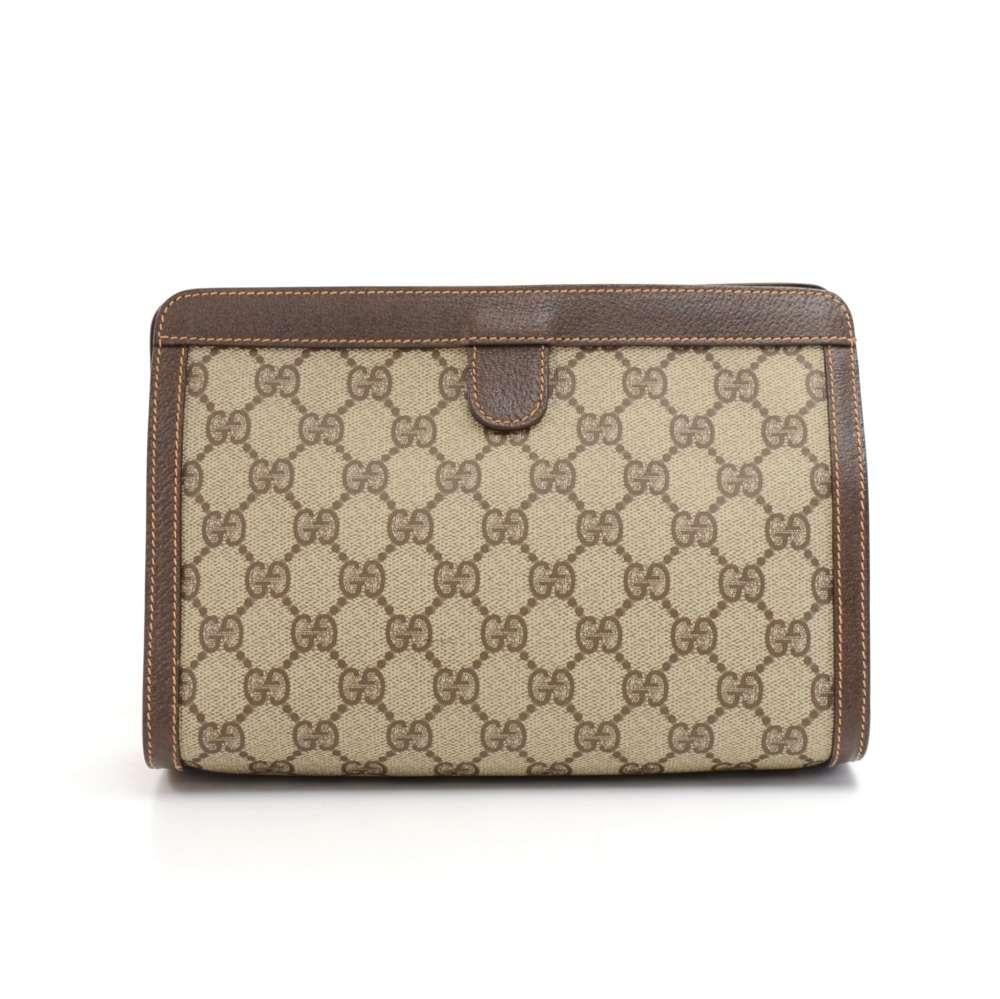 Gucci Clutch bag from the Gucci Accessory Collection made with GG Supreme Canvas, Brown leather, and the classic green and red web. The front has a Gold and Silver tone Double G Logo. The top is secured with a velcro. Inside is lined with tan