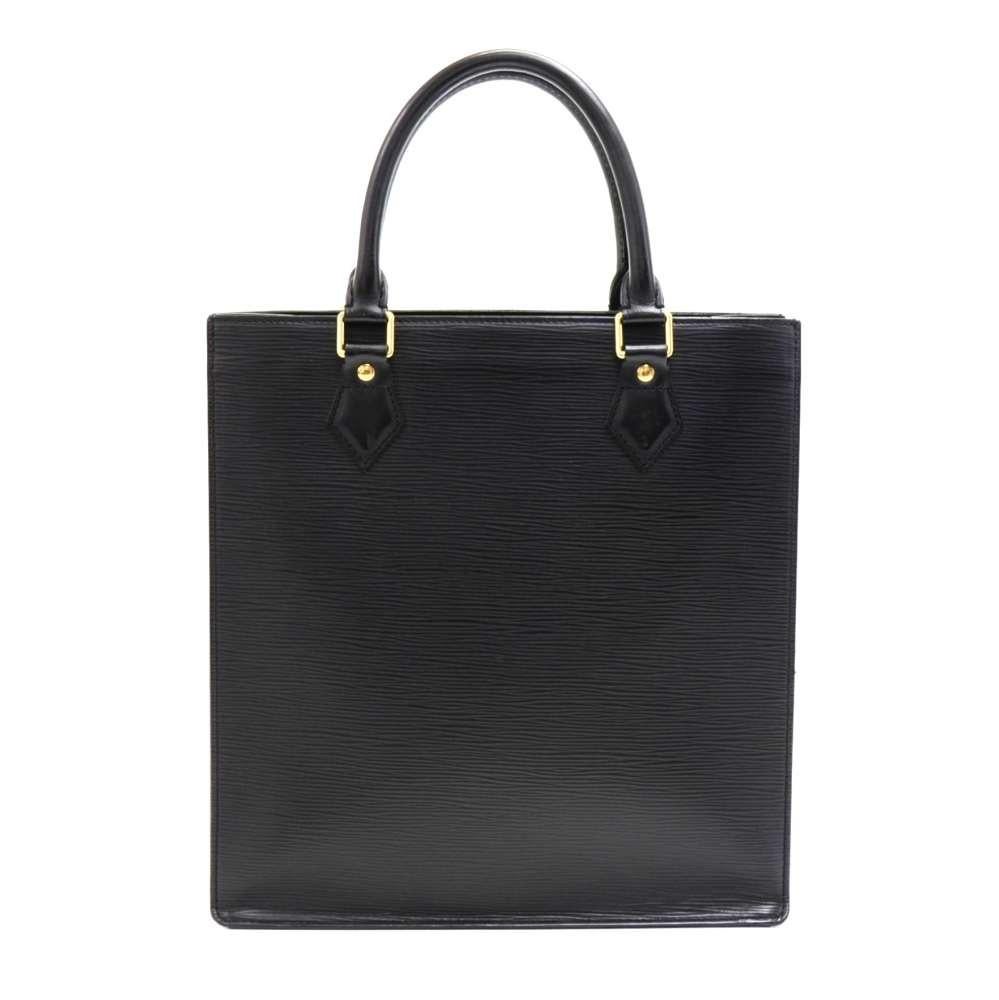 Louis Vuitton bag in Black Epi leather. It has 2 open pocket. Generously dimensioned to carry all your daily necessities. It fits all your magazines or work related paperwork.SKU: LQ080

Made in: France
Serial Number: RI0094
Size: 11.4 x 2.4 x 12