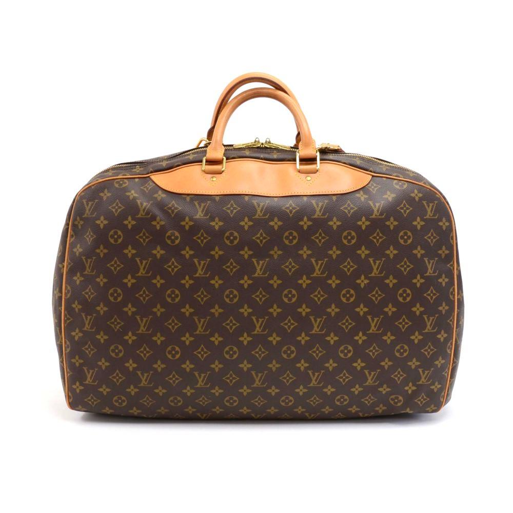 Vintage Louis Vuitton Alize 2 Poches travel bag in monogram canvas. One of the largest sturdy shoulder travel bag with leather handles and piping. It features two double-zip compartments, one with a large open pocket and the other compartment with a