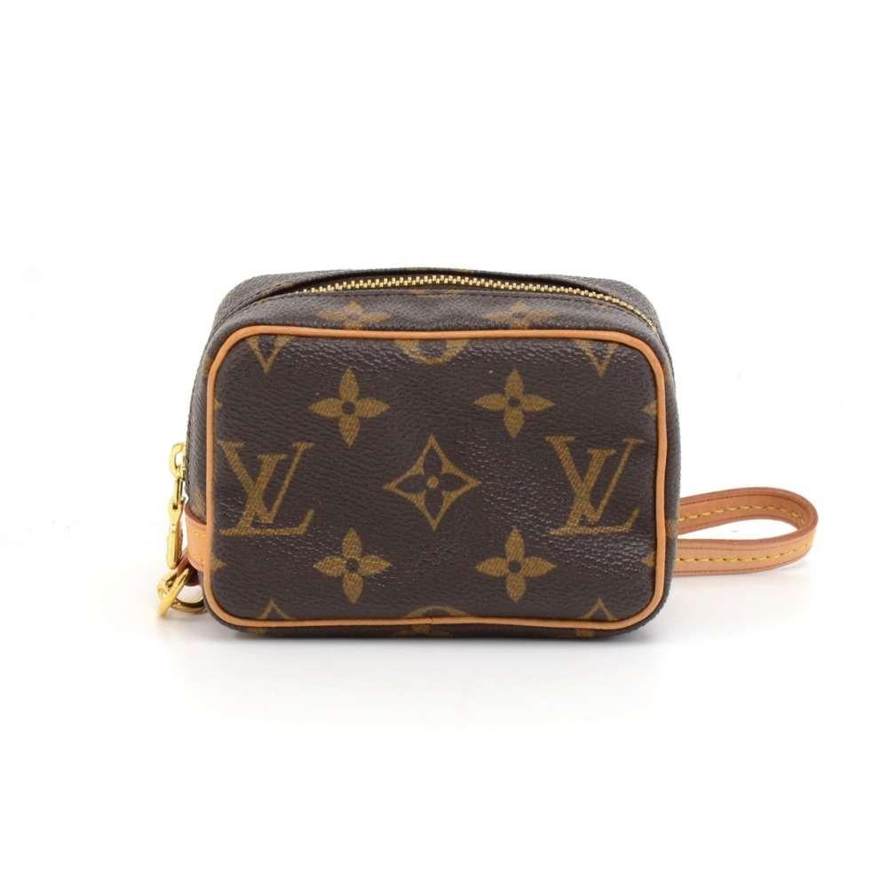 Louis Vuitton Trousse Wapity case in monogram canvas. Comes with a short removable leather Wristlet. Inside is in red alkantra lining and has open pocket. Great to keep many things secured like phones, cameras, cards, cosmetics, and keys. It would