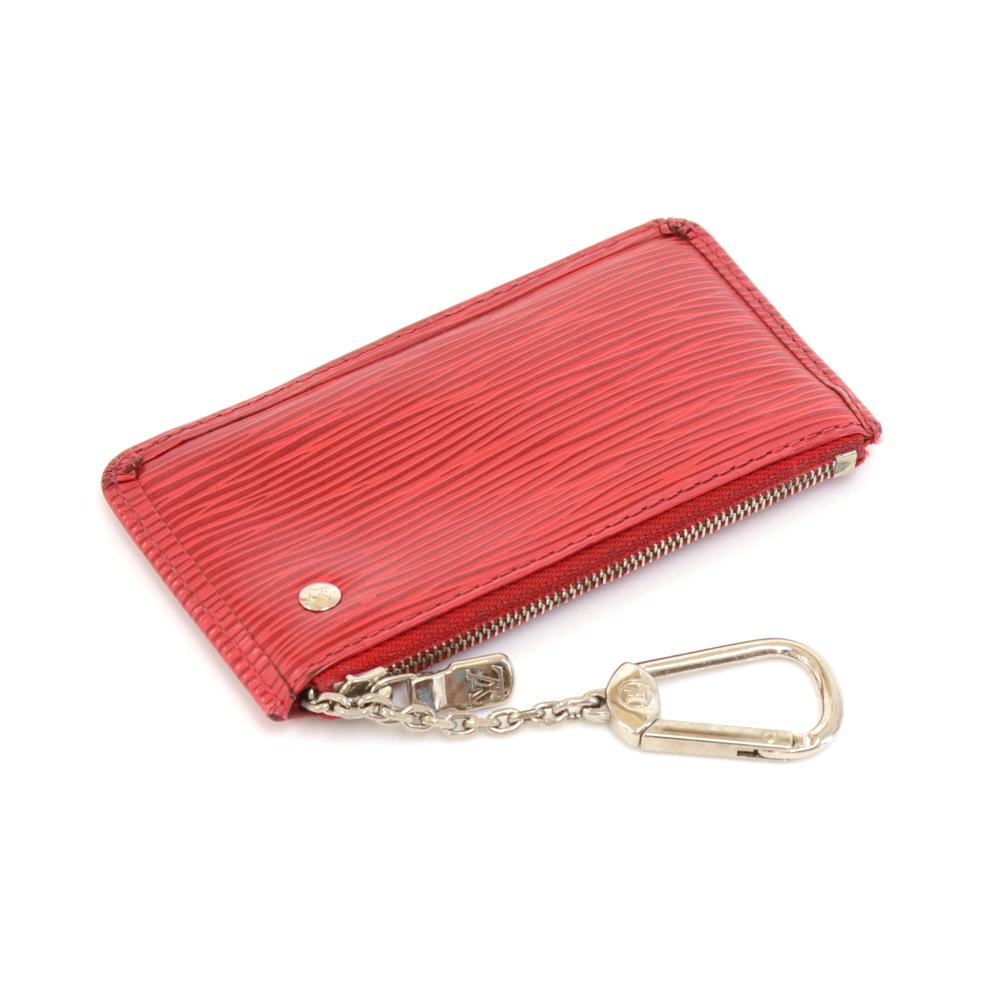 Authentic Louis Vuitton Epi Leather key/coin case. This key case is embossed Louis Vuitton initial, has key ring on a chain and holds some coins. Very cute!

Made in: Spain
Serial Number: CA2077
Size: 4.9 x 2.8 x 0.3 inches or 12.5 x 7 x 0.7
