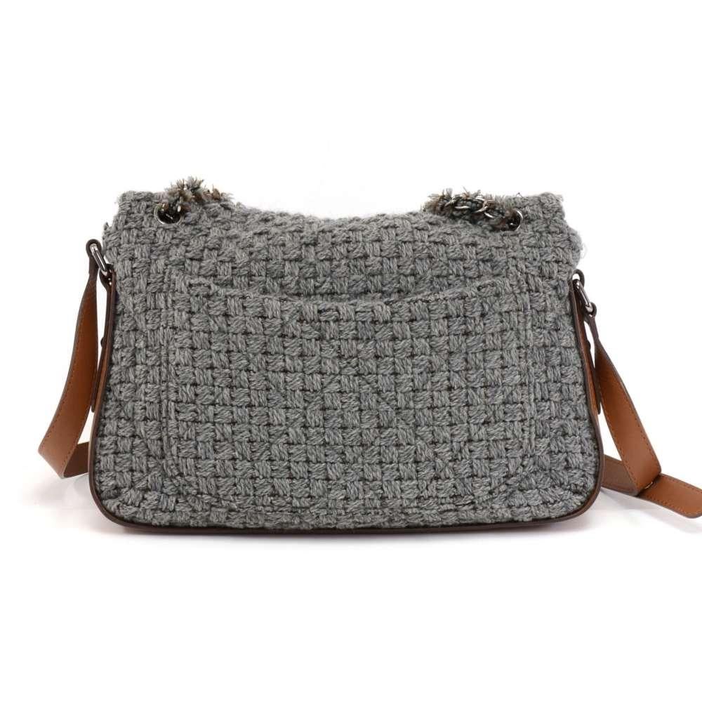 Chanel Shoulder flap bag in gray wool and brown leather. The gray wool has a bit of brown mixed in and has a check pattern with the classic Chanel quilted stitching on top. It has silver-tone hardware and Brown leather bottom, sides, and shoulder