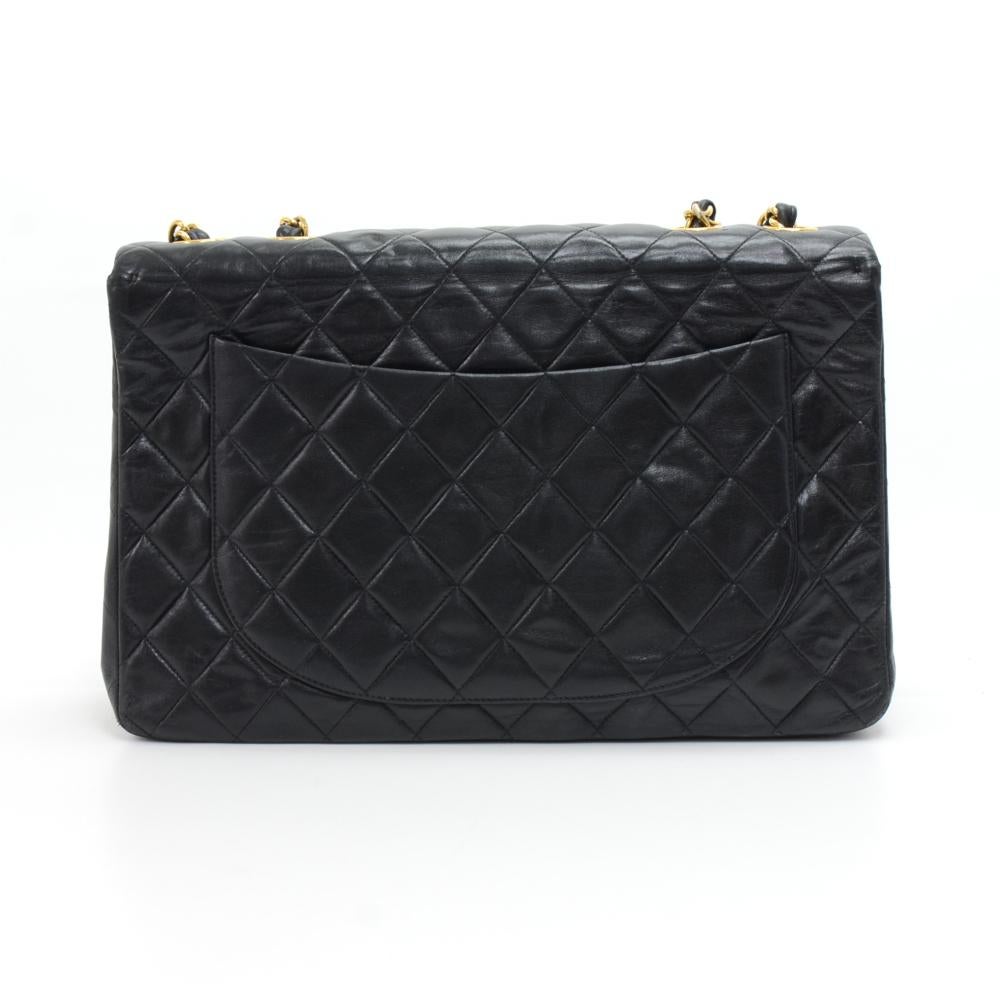 Chanel Maxi Jumbo in black quilted leather. It has flap top with famous large CC twist lock on the front. Outside on the back has 1 open side pocket. Inside has Chanel red leather lining and 2 pockets: 1 zipper and one open. Comfortably carried on