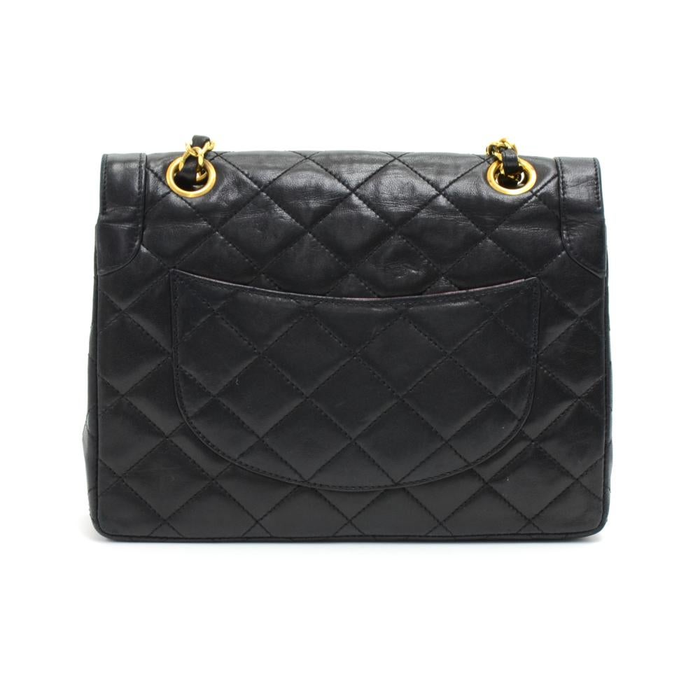 Authentic Chanel Paris Limited bag in quilted leather bag. It has flap closure with CC twist lock in 2 tones. Underneath the second flap has 1 open in pocket. Inside is lined with Chanel red leather. One open pocket separated into 3 compartments and