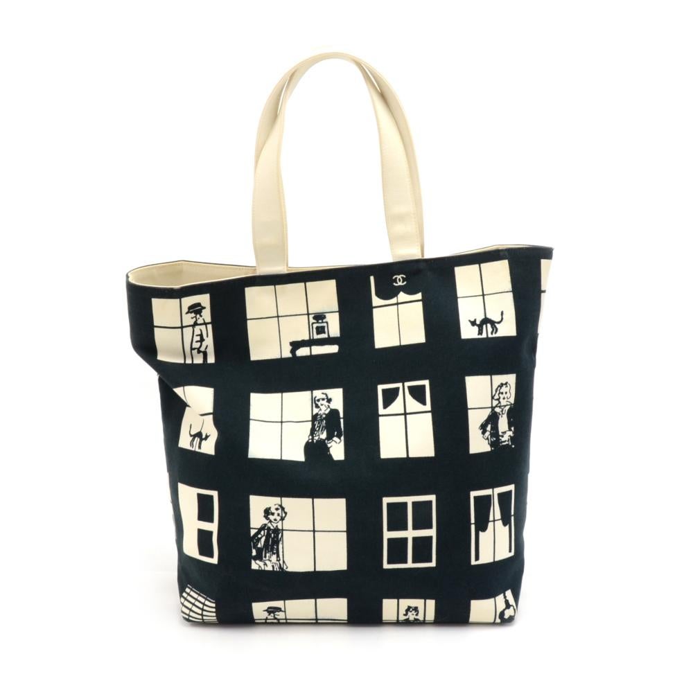 Chanel Canvas tote bag with the Coco Window Design. It has very cute illustrations of Coco Chanel and other women and a cat in the windows dressed in her classic clothes and bags. Very sturdy canvas with a structured rectangular bottom with rubber