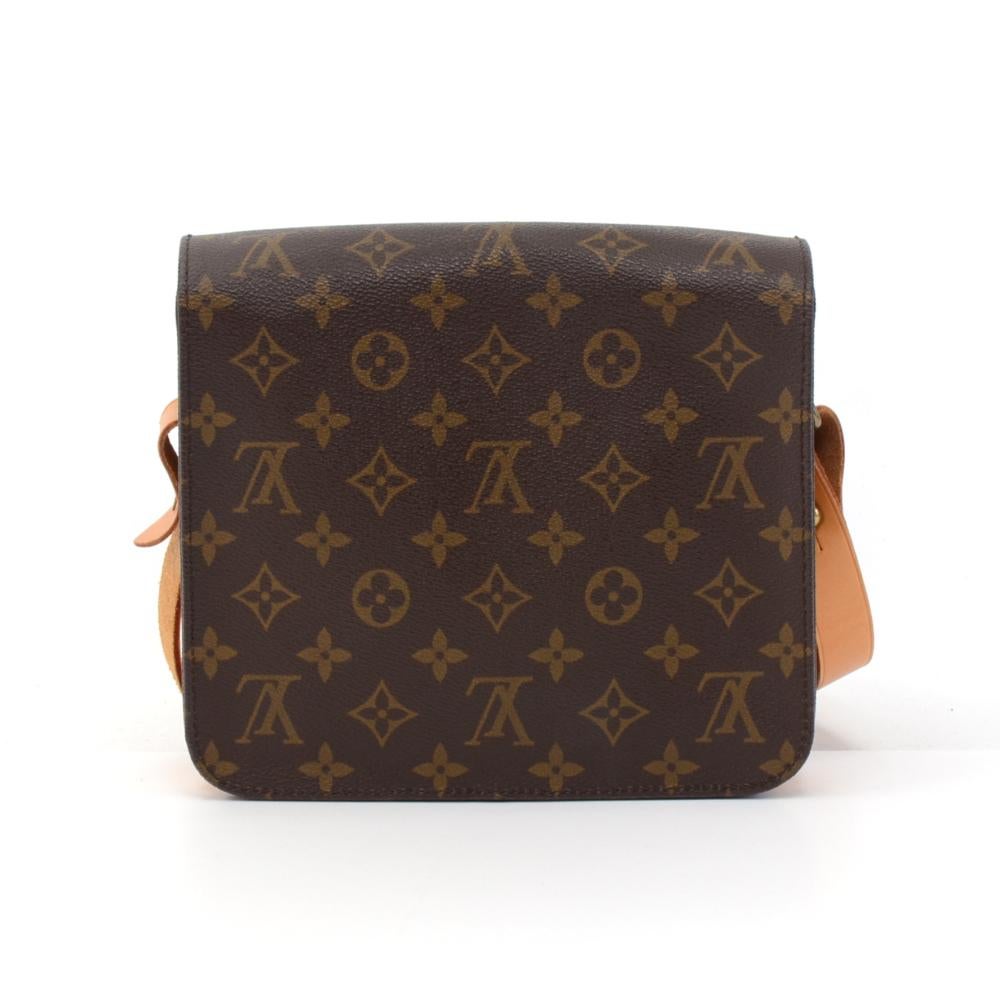 Vintage Louis Vuitton Cartouchiere MM in monogram canvas. Flap top secured with belt closure. Inside is brown lining separated into two compartments. Comfortably carry on shoulder or across body with cowhide leather strap. Great for your daily or