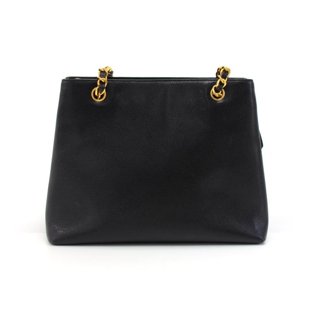 Chanel shoulder bag in black caviar leather. It has 1 flap pocket in an envelope shape with a large CC twist lock in front. Main access is secured with a zipper. Inside has black lambskin leather lining with 3 compartments. 2 open compartments, a