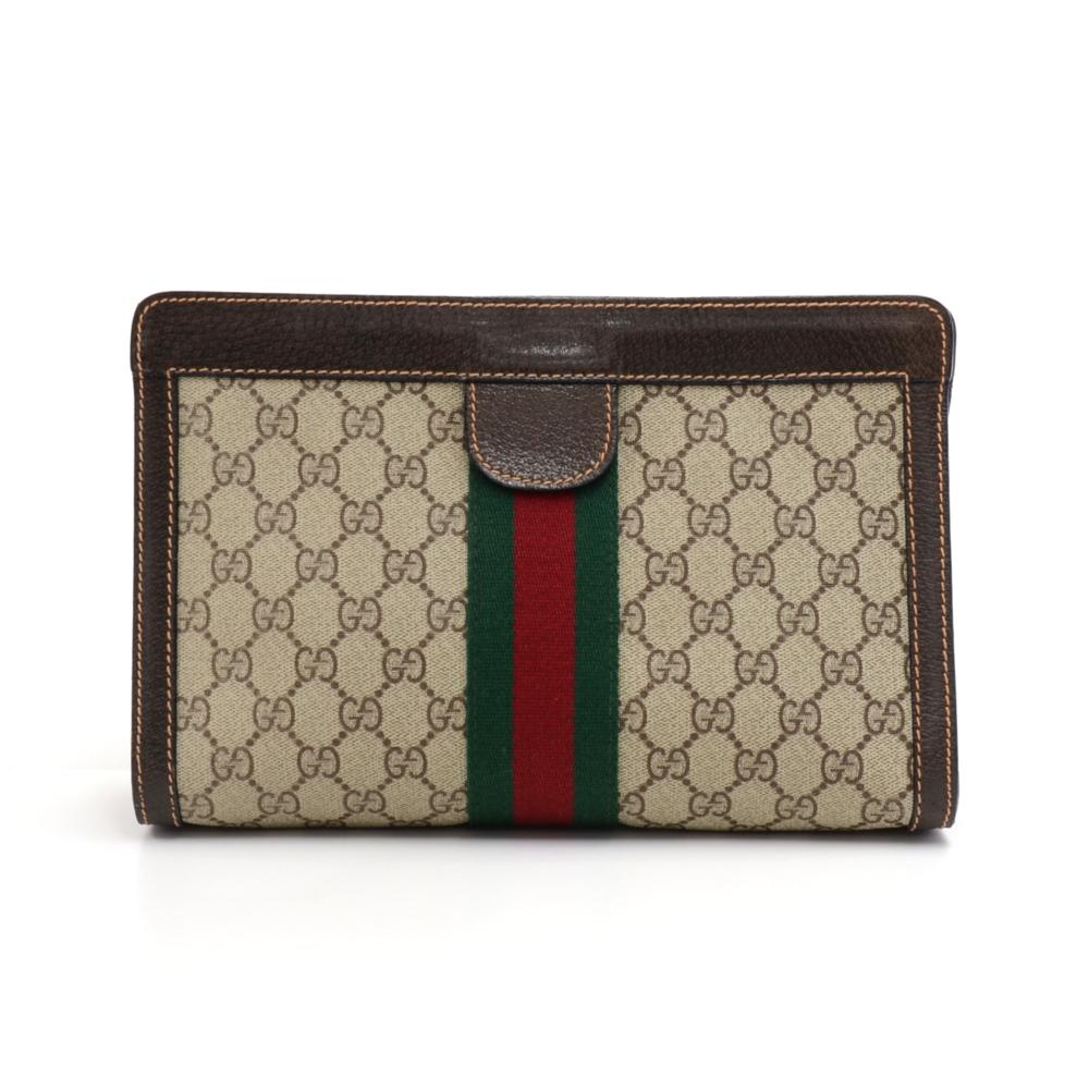 Gucci Clutch bag  made with GG Supreme Canvas, Brown leather, and the classic green and red web. The top is secured with  velcro. Inside is lined with a green fabric lining. Great as a clutch, or as pouch to store your items for travel, etc. A