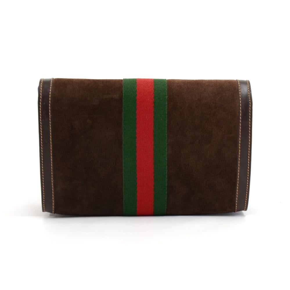 Authentic Gucci Clutch bag from the Gucci Accessory Collection made with Brown Suede leather, Brown leather, and the classic green and red web. The front has a Gold and Silver tone Double G Logo. The flap is secured with a stud lock. Inside is lined