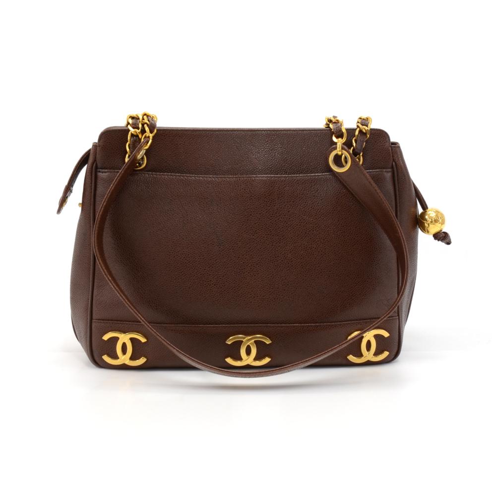 Vintage Chanel Triple CC logo Shoulder Bag in Brown Caviar Leather. The outside has 3 of the Classic Chanel CC logos going along the bottom on both sides of the bag. Outside has two exterior slip pockets. The main access is secured with a zipper