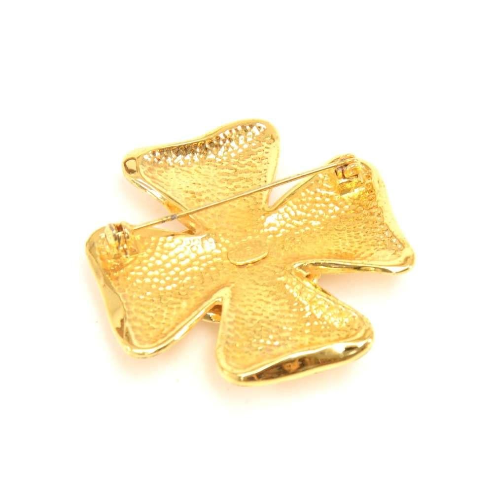 Vintage Chanel Gold-Tone Brooch. It has a 4 leaf clover design with a large CC logo in the center. The leaves of the clover are sprinkled with the letters making up 