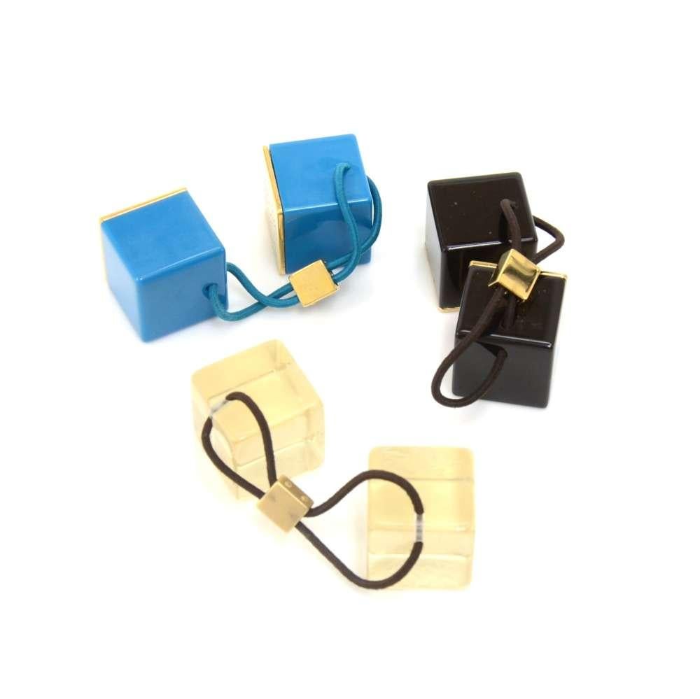 Louis Vuitton hair tie accessory in black, blue, and clear resin cubes. Each hair tie has two cubes with 